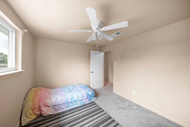 741 Rutgers Ln, Deer Park, TX 77536 - bedroom with light colored carpet and a ceiling fan