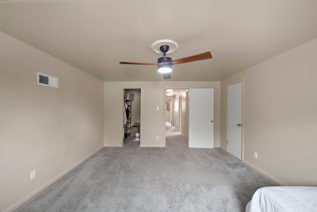 741 Rutgers Ln, Deer Park, TX 77536 - unfurnished bedroom featuring light colored carpet, a walk in closet, and a ceiling fan
