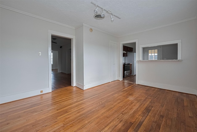 227 Lakeview Dr, Sugar Land, TX 77498 - empty room with wood finished floors, track lighting, crown molding, and a textured ceiling