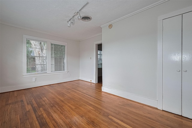227 Lakeview Dr, Sugar Land, TX 77498 - spare room with track lighting, wood finished floors, ornamental molding, and a textured ceiling