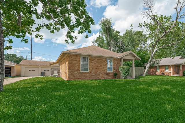 227 Lakeview Dr, Sugar Land, TX 77498 - view of front of house featuring brick siding, a front yard, driveway, an outdoor structure, and a shingled roof