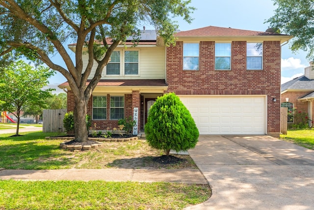 17203 Morning Blossom Pl, Houston, TX 77084 - traditional-style home with roof mounted solar panels, driveway, an attached garage, a front lawn, and brick siding