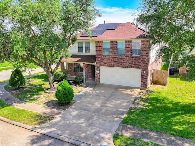 17203 Morning Blossom Pl, Houston, TX 77084 - traditional-style house featuring concrete driveway, roof mounted solar panels, brick siding, an attached garage, and roof with shingles