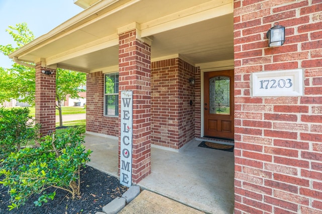 17203 Morning Blossom Pl, Houston, TX 77084 - doorway to property featuring brick siding and a porch