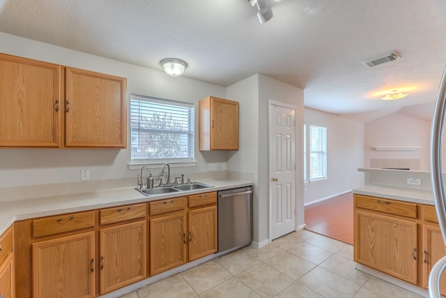 17203 Morning Blossom Pl, Houston, TX 77084 - kitchen with stainless steel dishwasher, healthy amount of natural light, light countertops, light tile patterned floors, and a textured ceiling