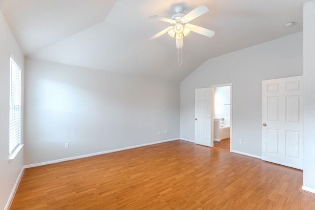 17203 Morning Blossom Pl, Houston, TX 77084 - unfurnished bedroom featuring lofted ceiling, multiple windows, light wood-type flooring, and ensuite bath
