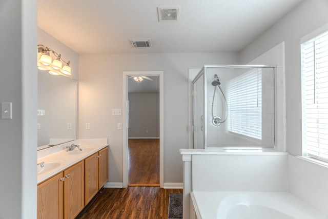 17203 Morning Blossom Pl, Houston, TX 77084 - full bath featuring double vanity, a garden tub, wood finished floors, a ceiling fan, and a shower with shower door