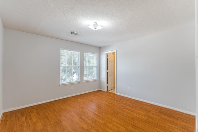 17203 Morning Blossom Pl, Houston, TX 77084 - empty room featuring light wood-style flooring and a textured ceiling