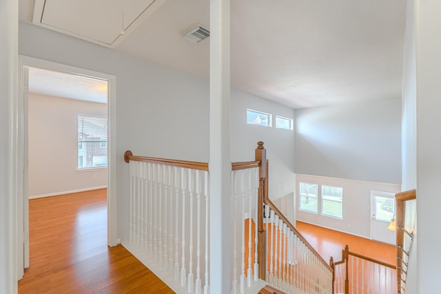 17203 Morning Blossom Pl, Houston, TX 77084 - corridor featuring an upstairs landing, attic access, wood finished floors, and healthy amount of natural light