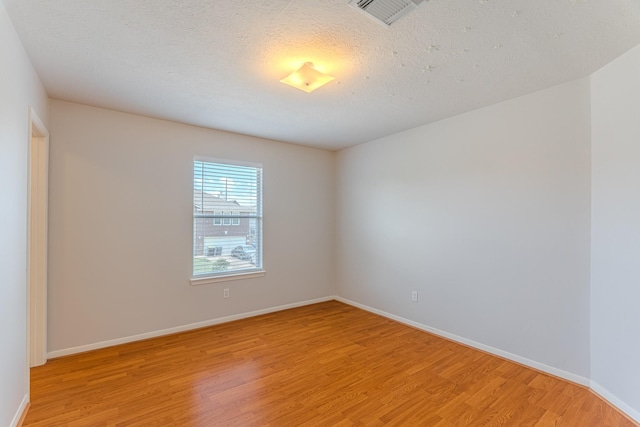 17203 Morning Blossom Pl, Houston, TX 77084 - spare room featuring light wood-style flooring and a textured ceiling