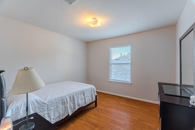 17203 Morning Blossom Pl, Houston, TX 77084 - bedroom featuring light wood-style flooring and a textured ceiling