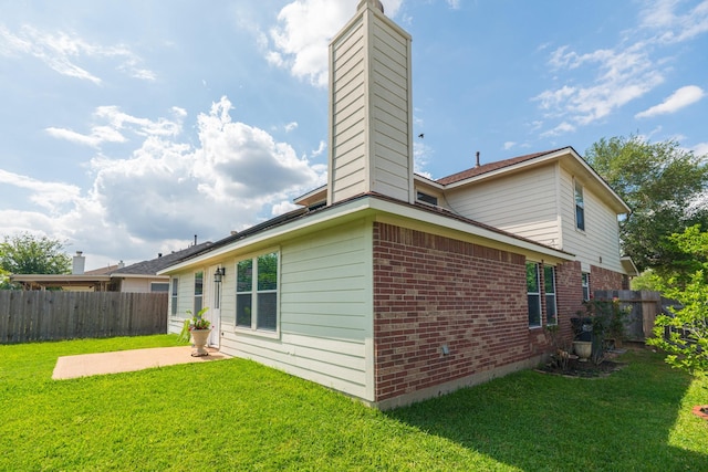 17203 Morning Blossom Pl, Houston, TX 77084 - back of house featuring a chimney, brick siding, and a patio