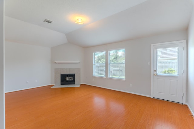 17203 Morning Blossom Pl, Houston, TX 77084 - unfurnished living room featuring light wood-type flooring, a fireplace, and lofted ceiling