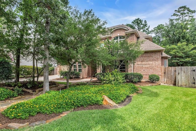 130 Amulet Oaks Ct, The Woodlands, TX 77382 - view of front of home featuring brick siding, a shingled roof, and a gate