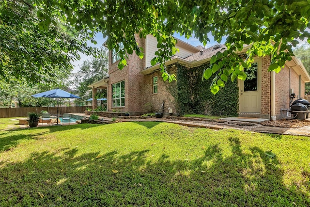 130 Amulet Oaks Ct, The Woodlands, TX 77382 - back of house with brick siding and a patio
