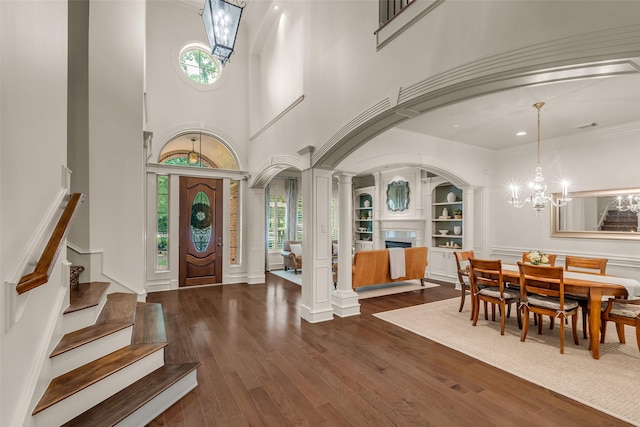 130 Amulet Oaks Ct, The Woodlands, TX 77382 - entrance foyer with plenty of natural light, a chandelier, dark wood finished floors, and stairs