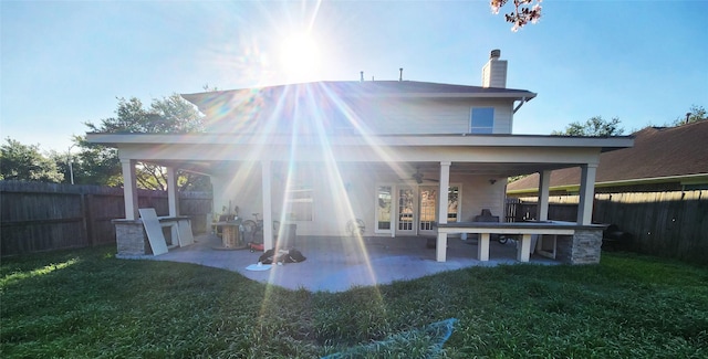 14631 Timber Cliff Ln, Cypress, TX 77429 - back of house featuring ceiling fan, a fenced backyard, a chimney, and a patio