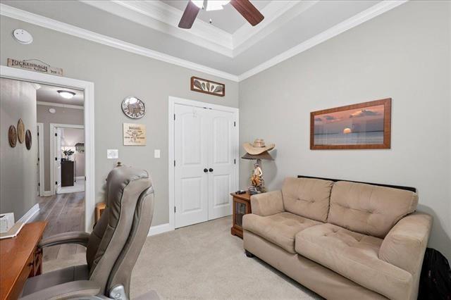 271 Hannah Ln, Lumberton, TX 77657 - office space with crown molding, a ceiling fan, a tray ceiling, and light carpet