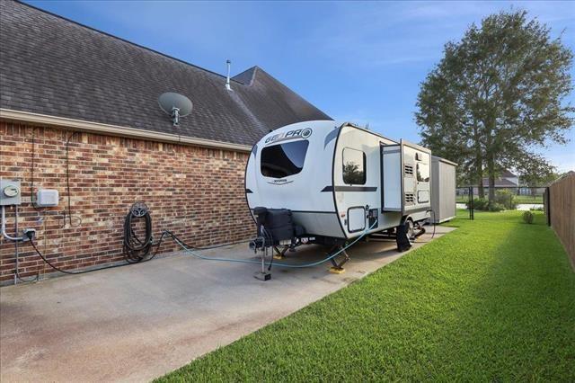 271 Hannah Ln, Lumberton, TX 77657 - view of side of home featuring brick siding and roof with shingles