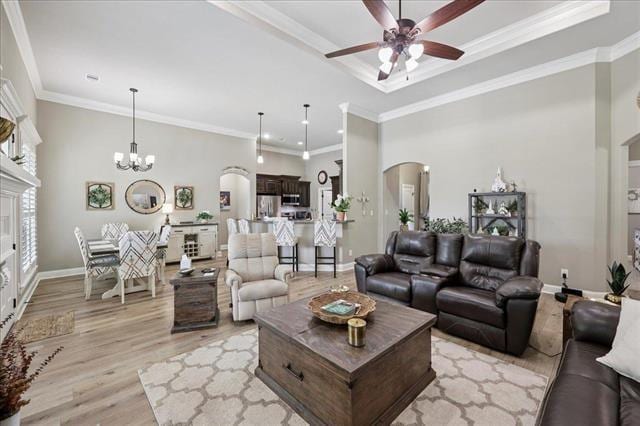 271 Hannah Ln, Lumberton, TX 77657 - living room featuring a ceiling fan, arched walkways, light wood-style flooring, ornamental molding, and a chandelier