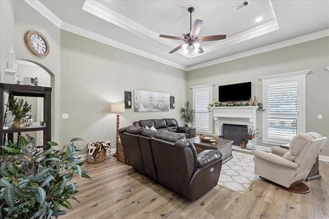 271 Hannah Ln, Lumberton, TX 77657 - living area with a raised ceiling, ceiling fan, light wood-type flooring, a fireplace, and ornamental molding