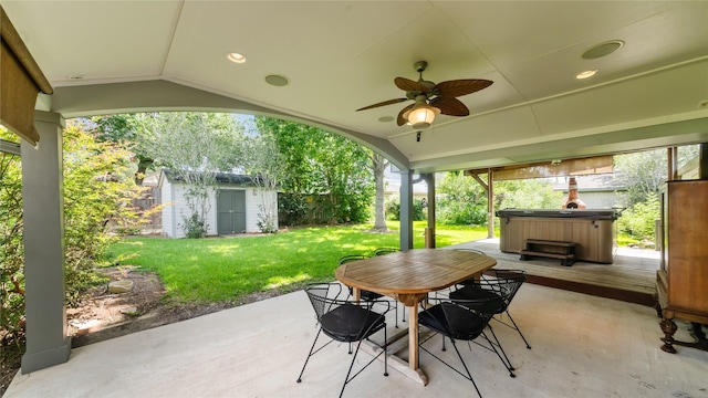 5010 Redstart St, Houston, TX 77035 - fenced backyard with a hot tub, a patio, a storage unit, ceiling fan, and outdoor dining space