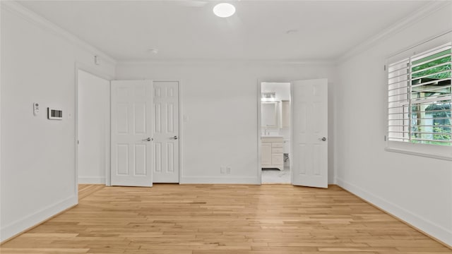 5010 Redstart St, Houston, TX 77035 - unfurnished bedroom featuring ornamental molding, light wood-style floors, and ensuite bath