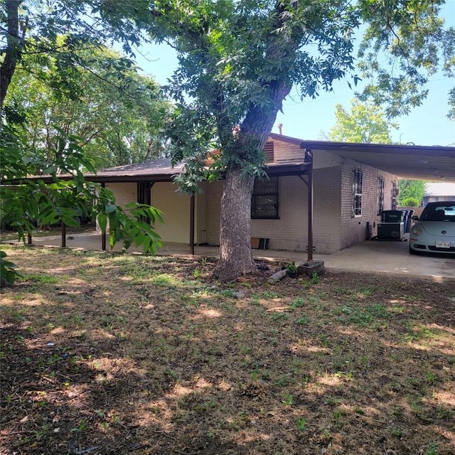 630 Alta Sita St, San Antonio, TX 78237 - view of side of property featuring an attached carport and brick siding