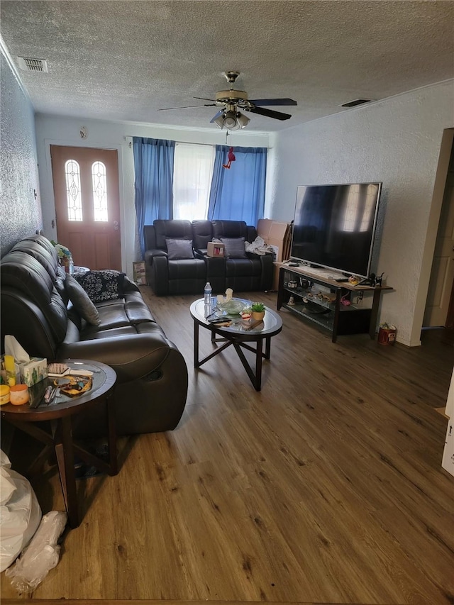630 Alta Sita St, San Antonio, TX 78237 - living room featuring wood finished floors, a textured ceiling, ceiling fan, and a textured wall