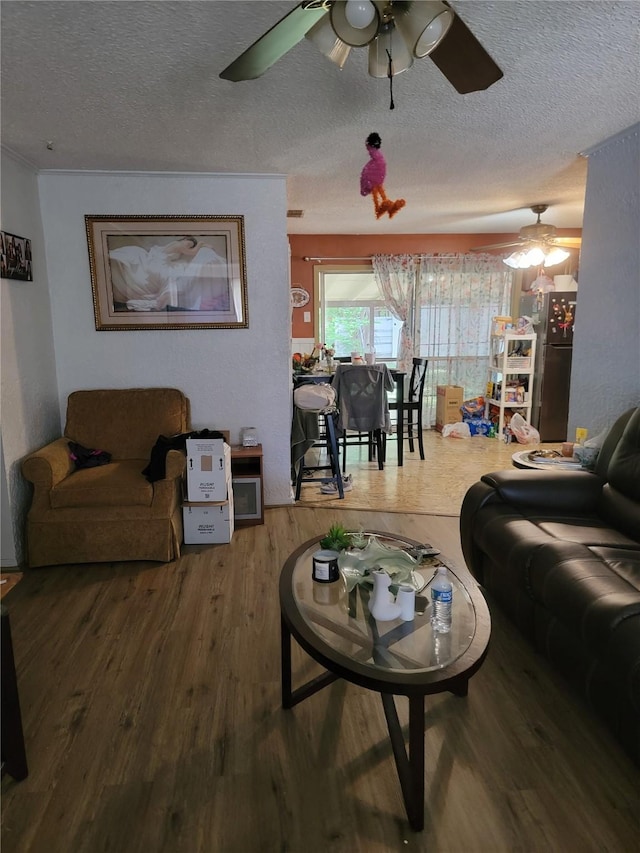 630 Alta Sita St, San Antonio, TX 78237 - living room with a textured ceiling, ceiling fan, and wood finished floors