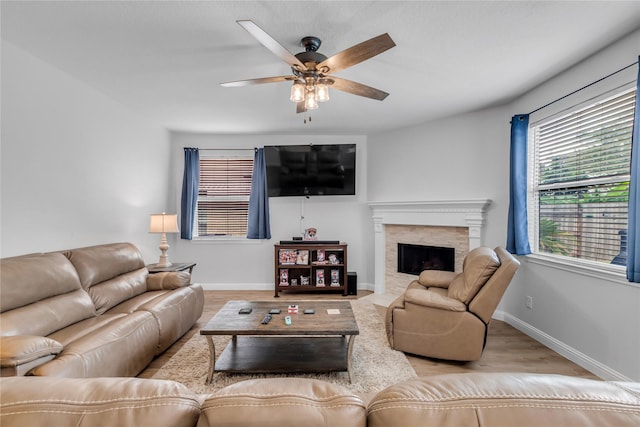 5506 Poundstone Ct, Sugar Land, TX 77479 - living area with wood finished floors, ceiling fan, and a fireplace with flush hearth