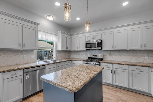 5506 Poundstone Ct, Sugar Land, TX 77479 - kitchen featuring stainless steel appliances, backsplash, decorative light fixtures, a kitchen island, and light stone countertops