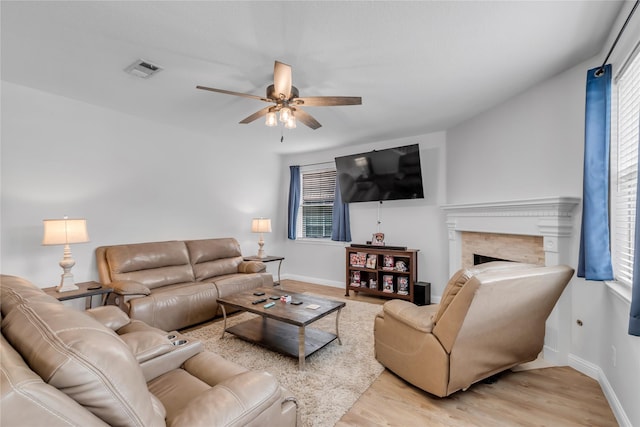 5506 Poundstone Ct, Sugar Land, TX 77479 - living room featuring a ceiling fan, light wood-style flooring, plenty of natural light, and a fireplace