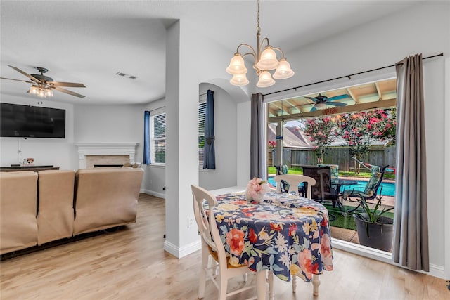 5506 Poundstone Ct, Sugar Land, TX 77479 - dining space featuring a ceiling fan, a chandelier, and wood finished floors