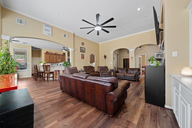 210 Southwood Cir, Baytown, TX 77520 - living room featuring ceiling fan, arched walkways, dark wood finished floors, and crown molding