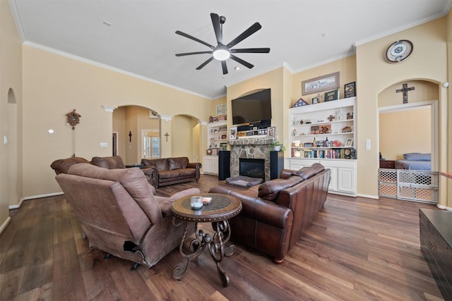 210 Southwood Cir, Baytown, TX 77520 - living room with arched walkways, a ceiling fan, a stone fireplace, crown molding, and built in features