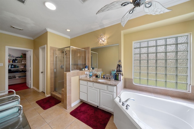 210 Southwood Cir, Baytown, TX 77520 - full bathroom featuring a stall shower, vanity, a bath, ornamental molding, and tile patterned flooring