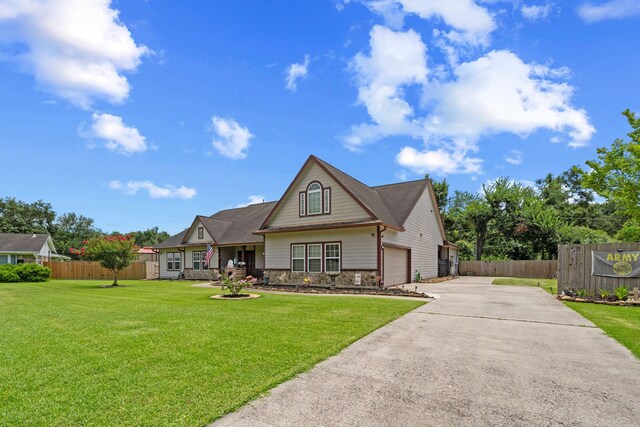 210 Southwood Cir, Baytown, TX 77520 - view of front facade with concrete driveway, stone siding, and an attached garage