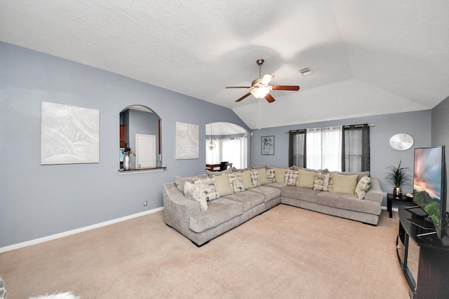 118 Long Canyon Ln, Richmond, TX 77469 - carpeted living area featuring arched walkways, a ceiling fan, and vaulted ceiling