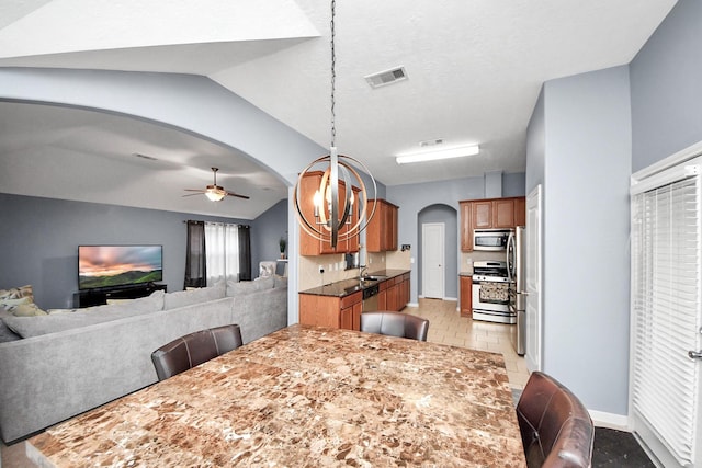 118 Long Canyon Ln, Richmond, TX 77469 - dining area featuring arched walkways, a ceiling fan, and vaulted ceiling