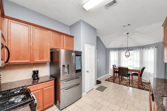 118 Long Canyon Ln, Richmond, TX 77469 - kitchen featuring stainless steel fridge, black gas range oven, backsplash, vaulted ceiling, and pendant lighting