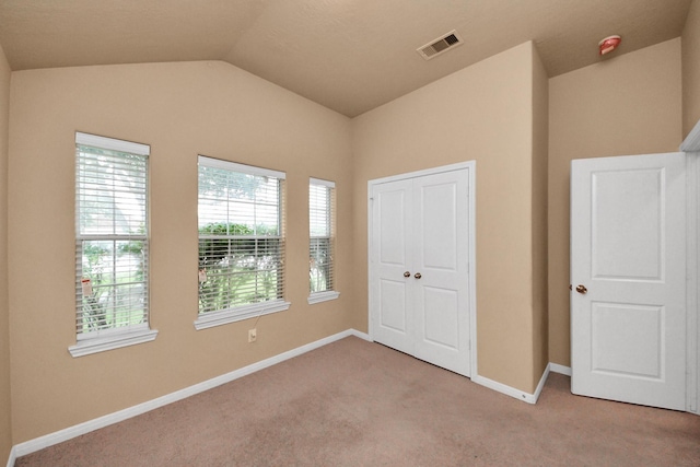 118 Long Canyon Ln, Richmond, TX 77469 - unfurnished bedroom featuring light carpet and vaulted ceiling