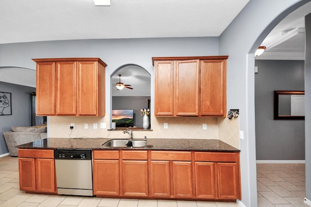 118 Long Canyon Ln, Richmond, TX 77469 - kitchen with stainless steel dishwasher, arched walkways, tasteful backsplash, dark stone counters, and light tile patterned floors