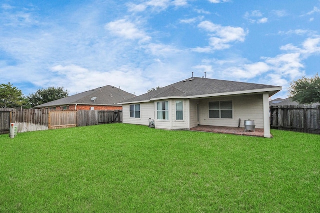 118 Long Canyon Ln, Richmond, TX 77469 - rear view of property featuring a fenced backyard, a shingled roof, and a patio area