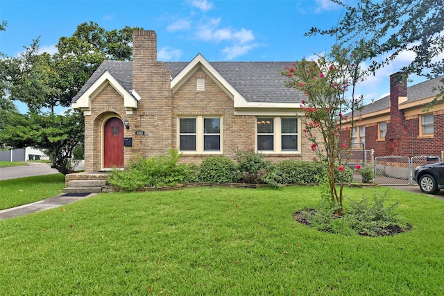 4701 Avenue N 1/2 Ave N 1/2, Galveston, TX 77551 - view of front of home featuring brick siding, a chimney, and roof with shingles