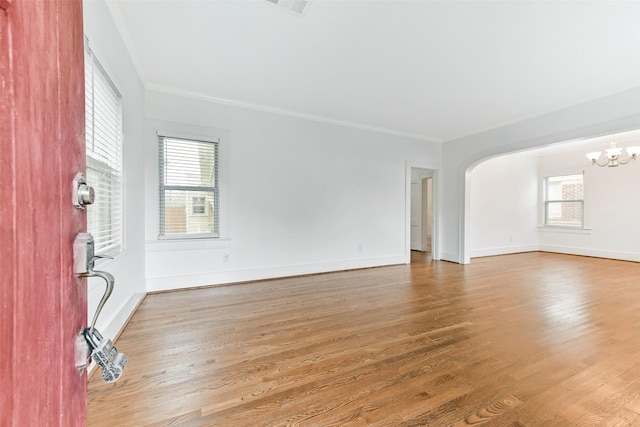 4701 Avenue N 1/2 Ave N 1/2, Galveston, TX 77551 - spare room featuring a chandelier, crown molding, wood finished floors, and arched walkways
