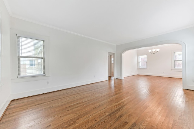 4701 Avenue N 1/2 Ave N 1/2, Galveston, TX 77551 - empty room with arched walkways, a chandelier, crown molding, and light wood-type flooring