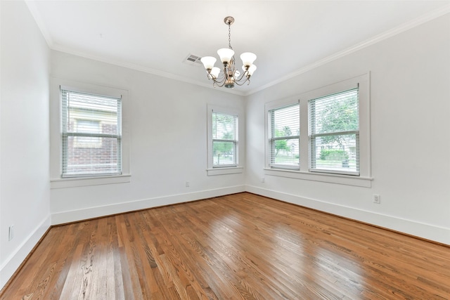 4701 Avenue N 1/2 Ave N 1/2, Galveston, TX 77551 - empty room featuring a chandelier, crown molding, and wood finished floors