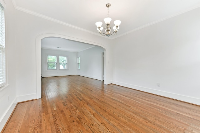 4701 Avenue N 1/2 Ave N 1/2, Galveston, TX 77551 - empty room with arched walkways, a chandelier, wood finished floors, and crown molding