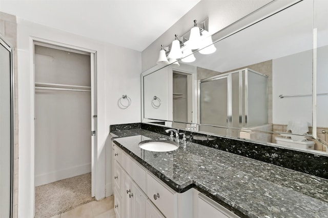 4701 Avenue N 1/2 Ave N 1/2, Galveston, TX 77551 - bathroom with a stall shower, vanity, a spacious closet, and tile patterned floors
